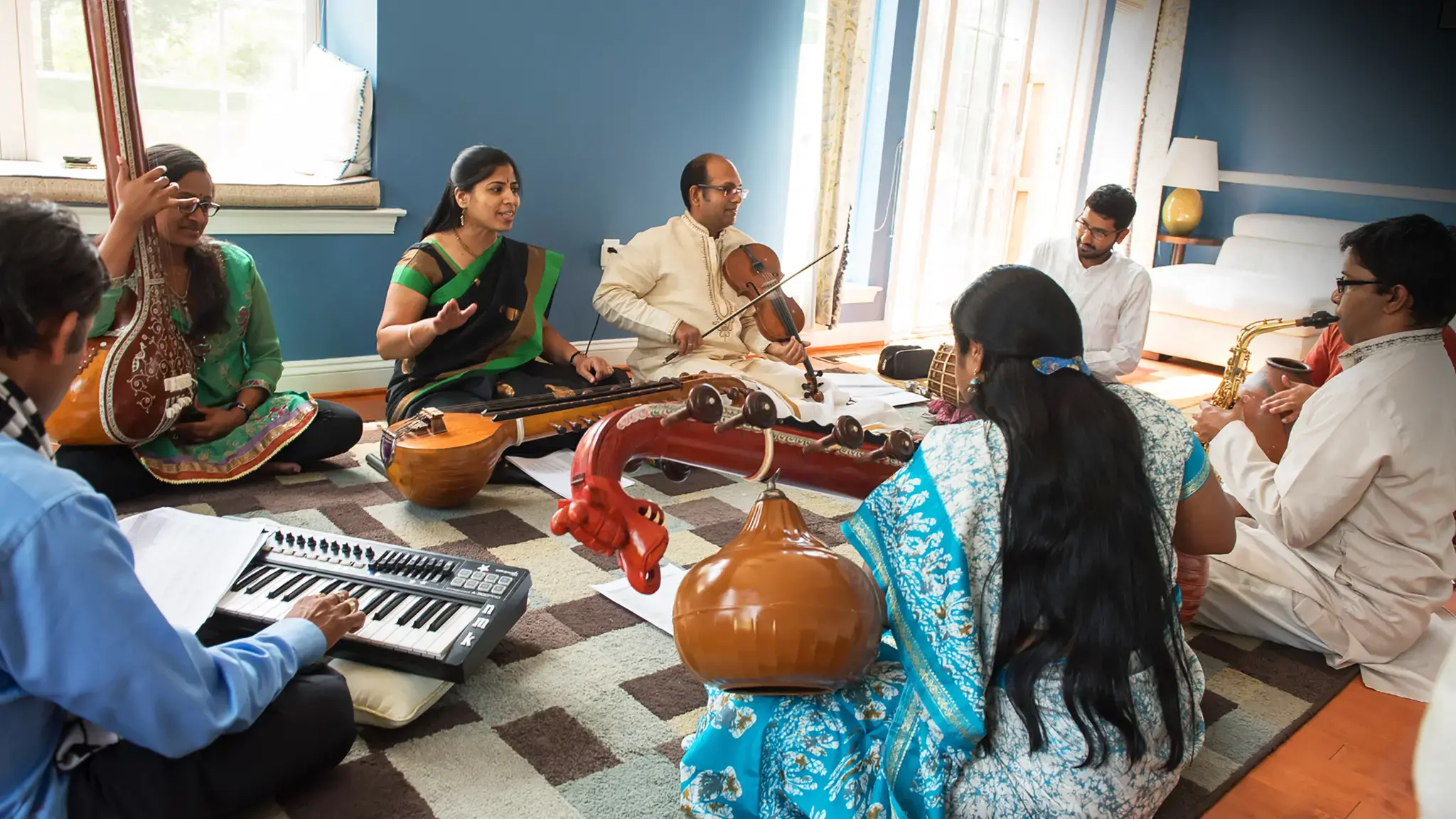 Artists N Muralikrishnan (Keyboard), Shruthi Rajasekar (Tambura), Kiranavali Vidyasankar (Voice &amp; Chitravina), V V S Murari (Violin), Akshay Anantapadmanabhan (Kanjira &amp; Konnakkol), Ravi Balasubramanian (Ghatam), Prasant Radhakrishnan (Saxophone) &amp; Nirmala Rajasekar (Vina) during rehearsals for Tradition &ndash; An Evolving Continuum. Photo by Nan Melville.