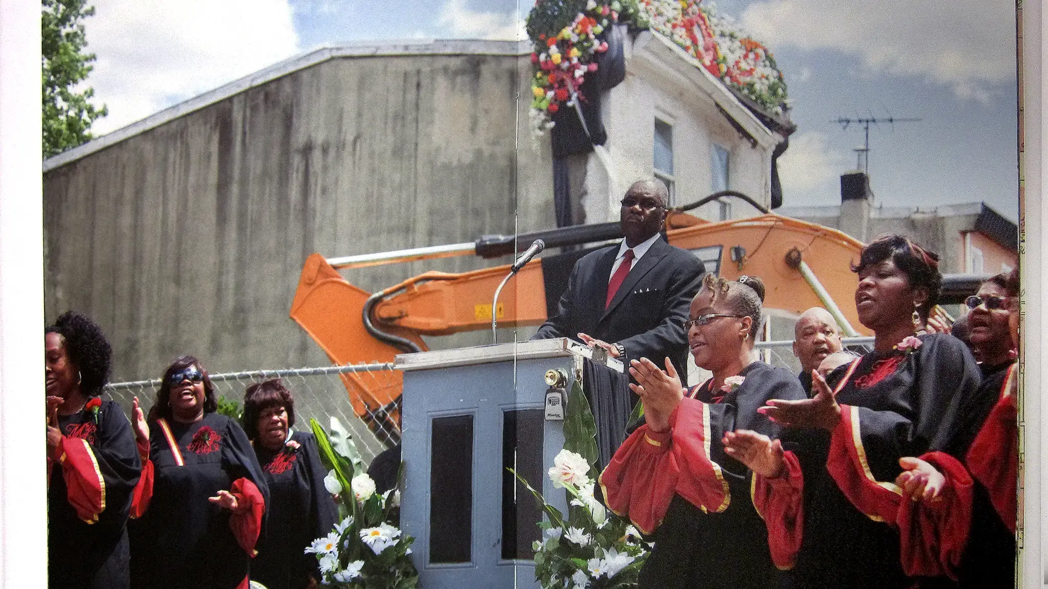 Pastor Harry Moore, Sr. of Mount Olive Baptist Church approaches the lectern remodeled with 3711 Melon Street&rsquo;s front door, as his choir performs at the funeral service for the row home. Interior detail of Temple Contemporary&rsquo;s publication for Funeral for a Home.