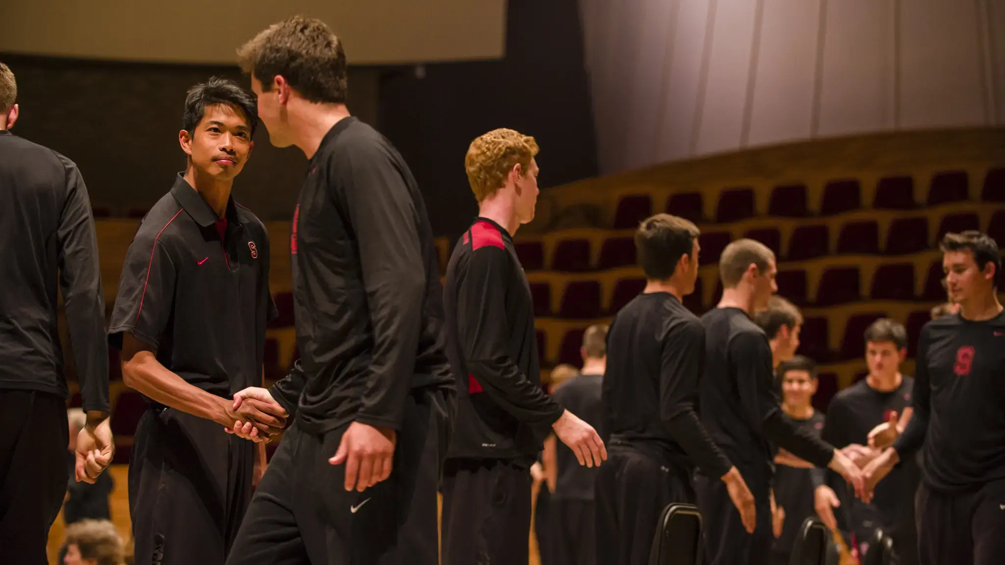 Volleyball players shake hands as part of Ann Carlson&#39;s The Symphonic Body: Stanford at the Performance Studies International 19 conference, June 2013. Photo by Toni Gauthier.