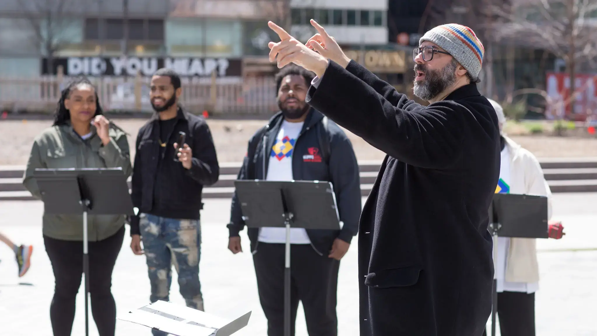 Lead artist and composer Ari Benjamin Myers conducts “Duet” in Love Park, Rehearsing Philadelphia, Curtis Institute of Music and Drexel University’s Westphal College of Media Arts &amp; Design, 2022. Photo by Conrad Erb.