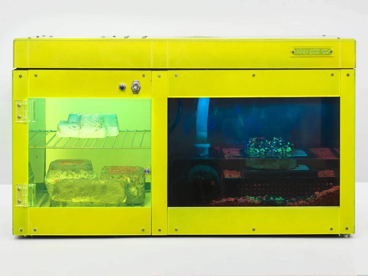 Carl Cheng/John Doe Co., Erosion Machine No. 4, 1969; plexiglass, metal racks and fittings, plastic, water pump, LED lights, black light, pebbles, erosion rocks, wood base; 15" x 25" x 9". Photo by Jeff McClane, courtesy of Carl Cheng and Philip Martin Gallery.