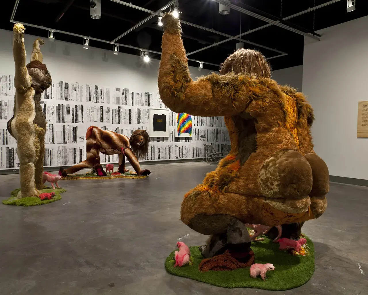 Installation shot of Alien She at the Miller Gallery at Carnegie Mellon University: Foreground: Allyson Mitchell, Ladies Sasquatch, 2006-2010, found textiles, taxidermy supplies, appliqué borg, styrofoam, wood. Background: Allyson Mitchell, Recommended Reading, 2010, wallpaper of photocopied drawings. Photo courtesy of the artist and Katharine Mulherin Gallery, Toronto.