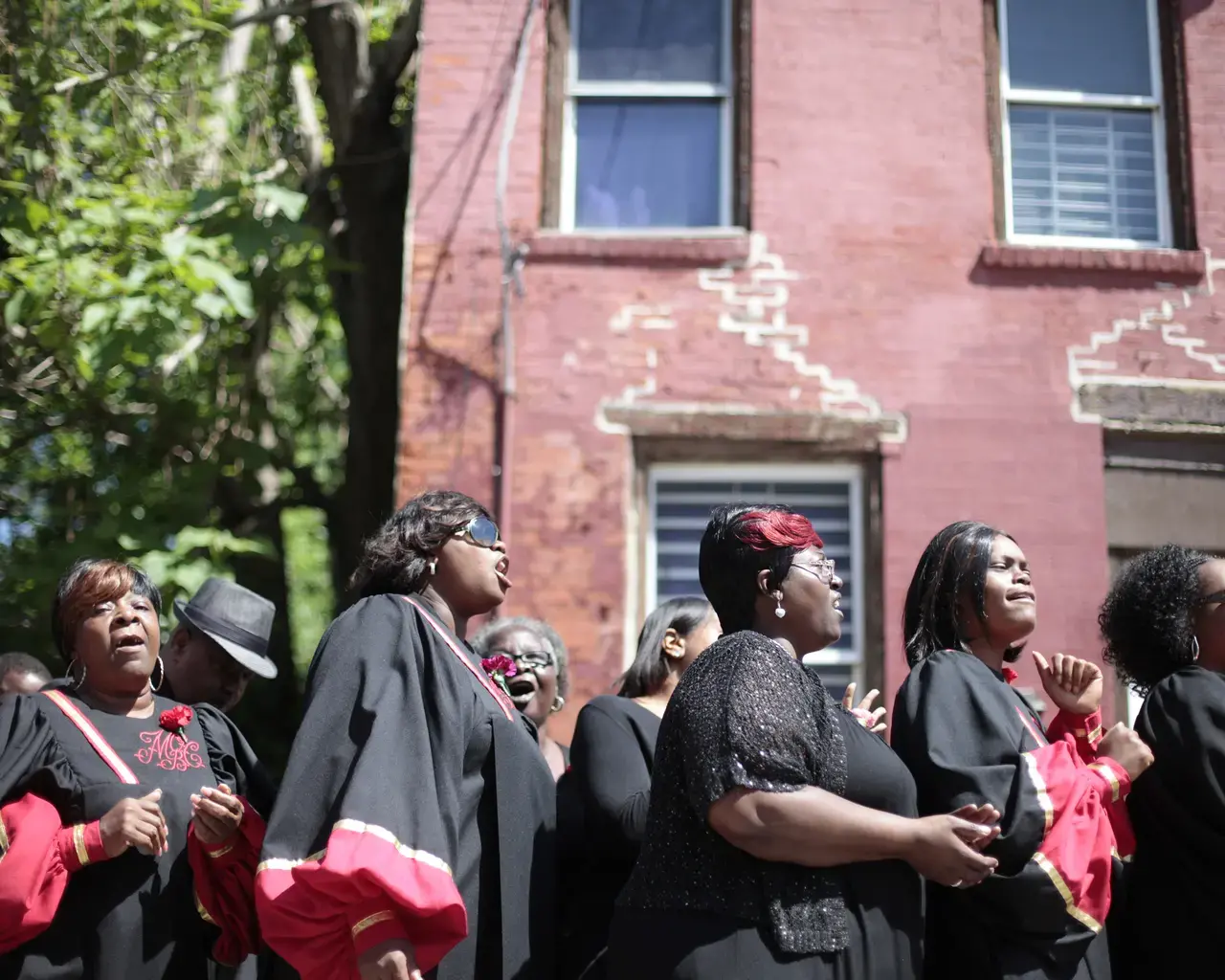 Members of Mt. Olive Baptist Church Choir sing at 3711 Melon Street during Temple Contemporary&#39;s Funeral for a Home service on Saturday, May 31, 2014. Photo: AP/Jessica Kourkounis.