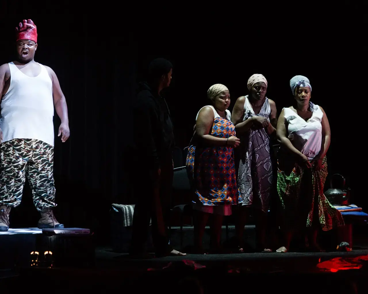 Owen Metsileng, with chorus singers Philisa Sibeko, Thomakazi Holland, and Jacqueline Manciya in Brett Bailey&rsquo;s Macbeth. Photo by Dominic M. Mercier.