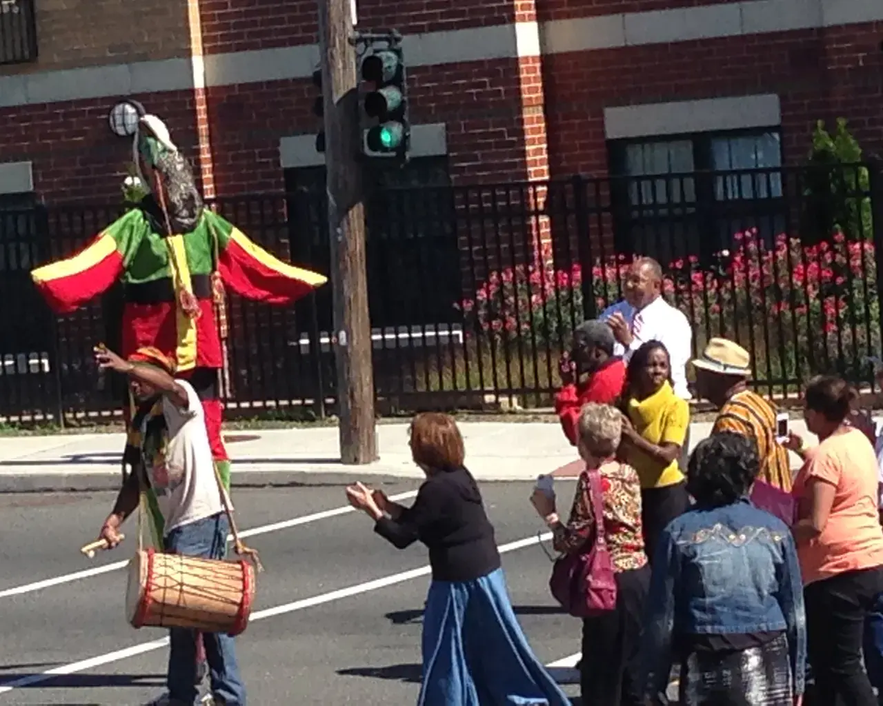 Deshong Commemoration Day, with a stilt walker from the African Masquerade Society of Philadelphia leading the Mayor and the people of Chester in a symbolic cultural walk to clear the path for spiritual restoration in the park. Photo courtesy of the Pennsylvania Humanities Council.
