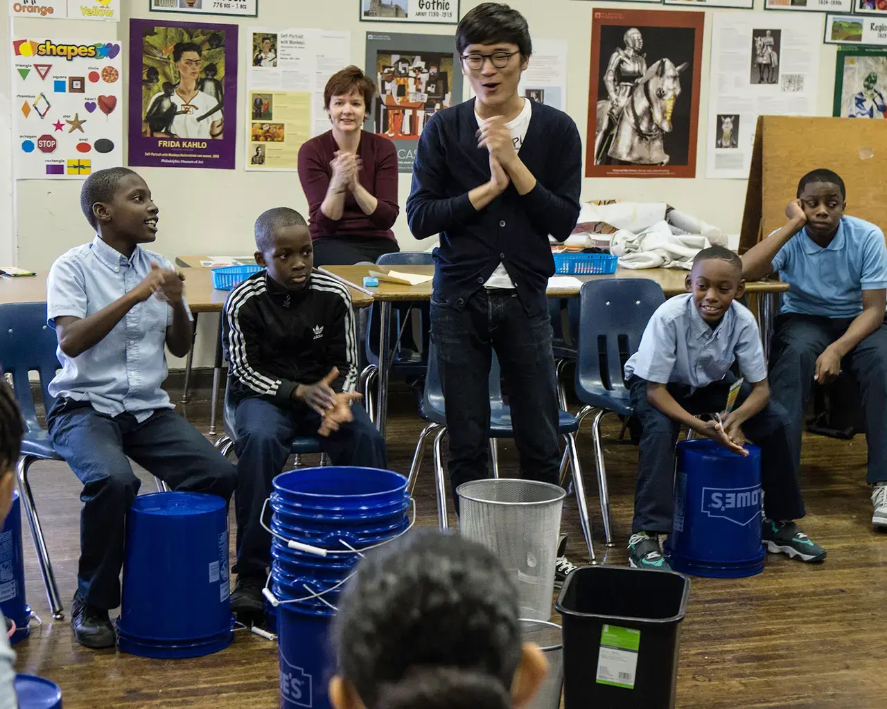 Curtis student percussionist Won Suk Lee leads his Social Entrepreneur project&mdash;training a bucket band of fifth-graders&mdash;at Philadelphia&rsquo;s Kearny Elementary School, 2014. Photo by Harris Sklar.