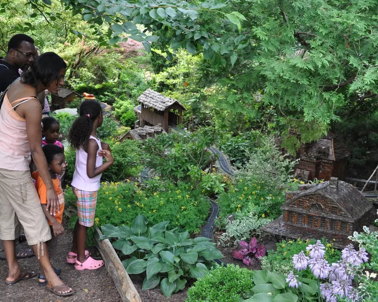 Visitors young and old enjoy the magic of Morris Arboretum&#39;s outdoor Garden Railway display. Courtesy of the Morris Arboretum.