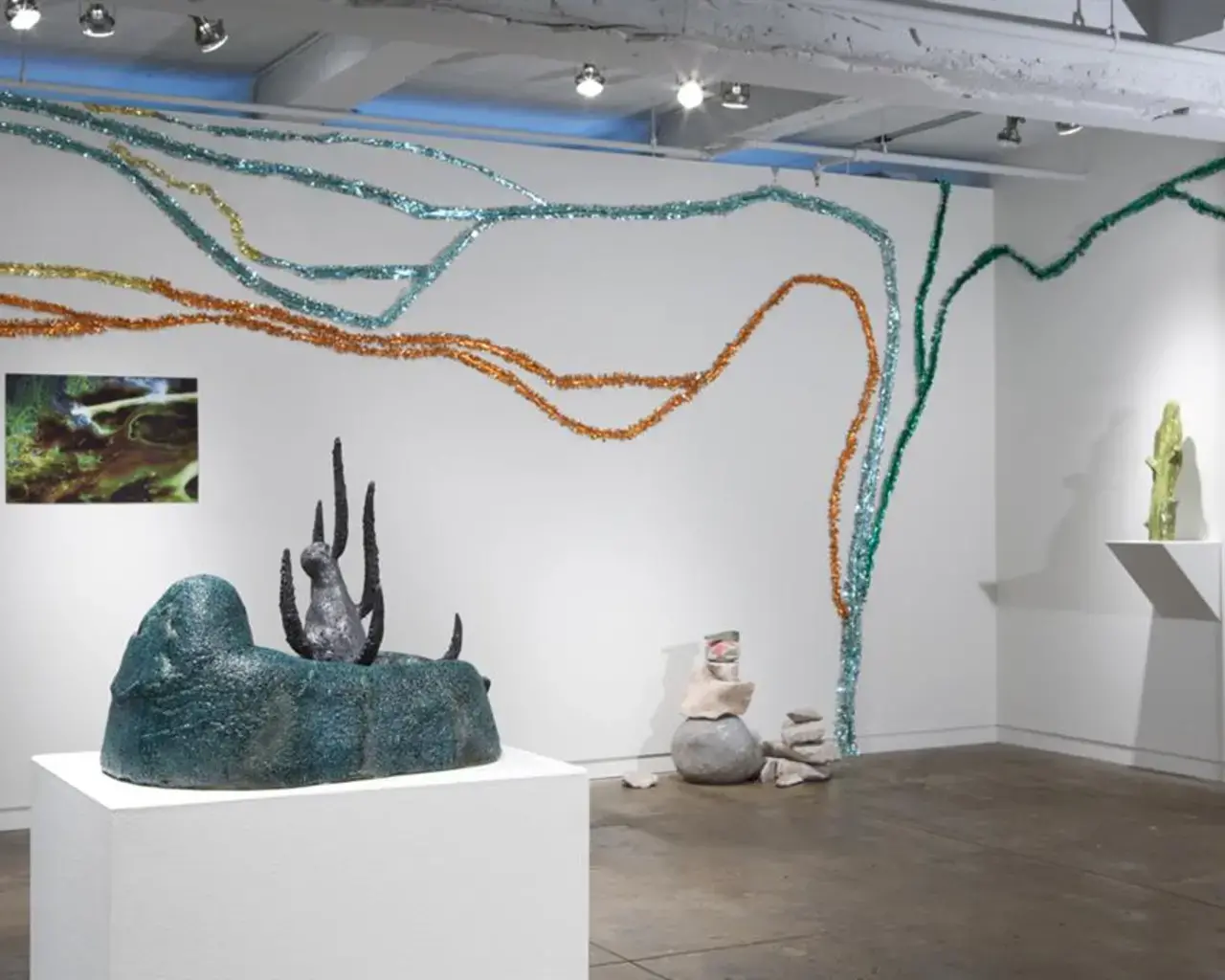 Paul Swenbeck, Mocha Dick, 2009, Invisible World&nbsp;installation view. Ceramic, resin, aluminum foil, photographs. Photo courtesy of the artist.