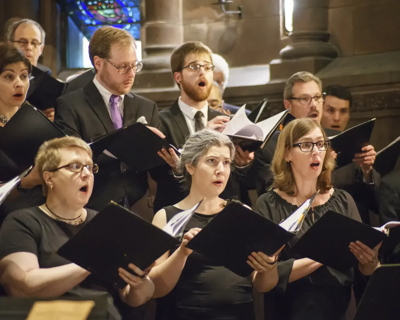 Members of Choral Arts Philadelphia during a pre-concert warm-up, alto and bass section. Photo by Sharon Torello.