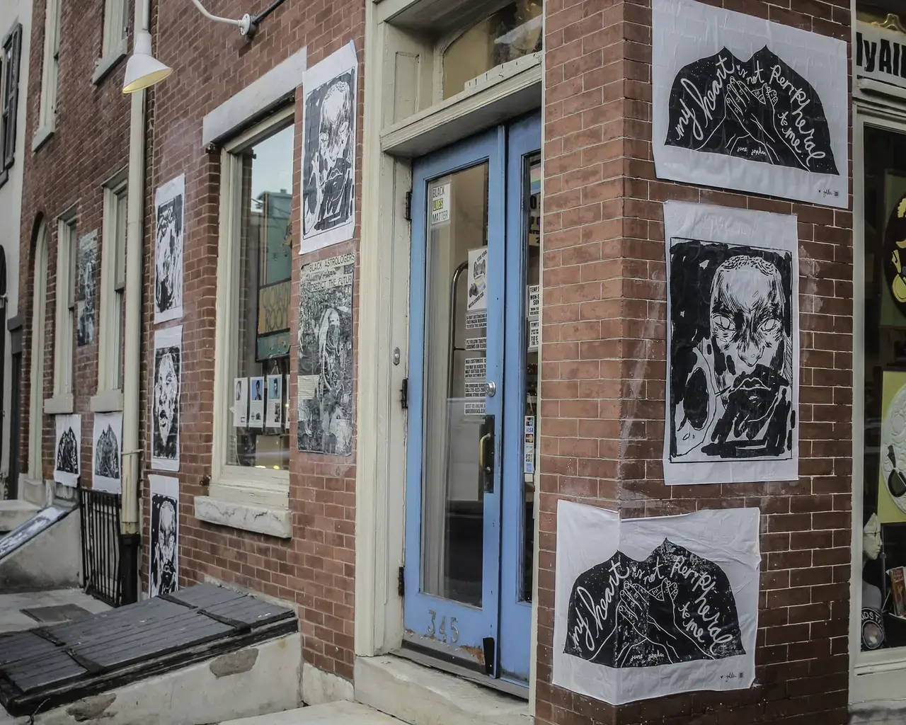 Unity at the Initiative,&nbsp;posters for&nbsp;wheatpaste&nbsp;gallery at Philly AIDS Thrift&nbsp;at&nbsp;Giovanni's Room, 2021.&nbsp;Pictured:&nbsp;not peripheral&nbsp;by Golden Collier,&nbsp;BLACK QUANTUM FUTURISM&nbsp;by Moor Mother, and&nbsp;untitled&nbsp;by Soleil Summer.&nbsp;Photo by&nbsp;Zsa&nbsp;Zsa&nbsp;Dali.&nbsp;