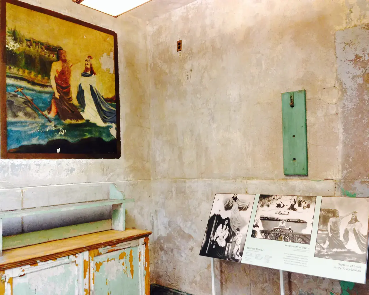 The completed Catholic Chaplain&rsquo;s Office includes new signs interpreting the space and the murals. Courtesy of Eastern State Penitentiary.
