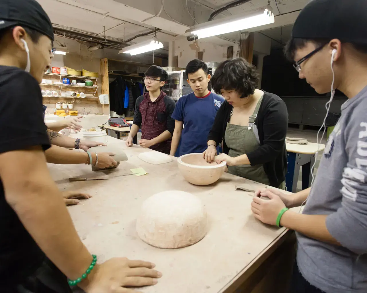 Teaching artist Joan Oh leading high school students from VietLEAD in a Vietnamese ceramics workshop. Photo by Dominic Mercier.