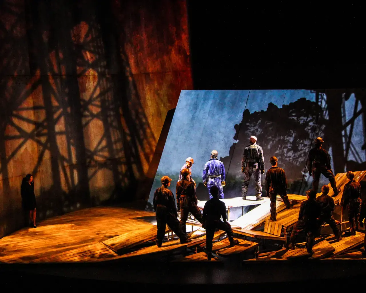 The oil workers, portrayed by members of the Opera Philadelphia Chorus, toil on the rig in Breaking the Waves. Photo by Nicholas Korkos.