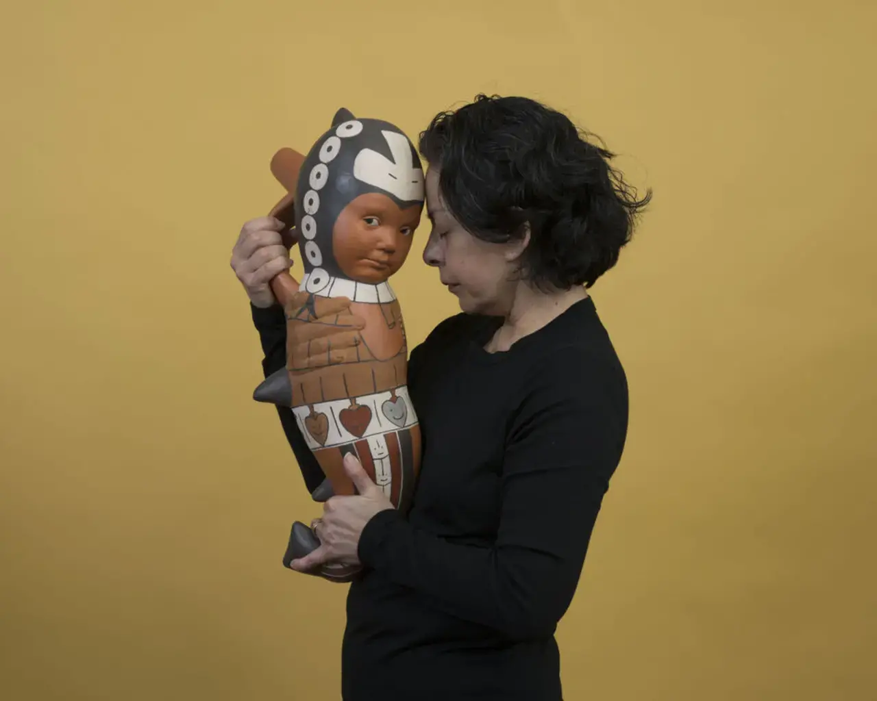Pew Fellow Kukuli Velarde poses with a ceramic sculpture from her series&nbsp;A Mi Vida,&nbsp;part of the exhibition&nbsp;Making Place Matter&nbsp;at The Clay Studio, Philadelphia. Photo by John Carlano.