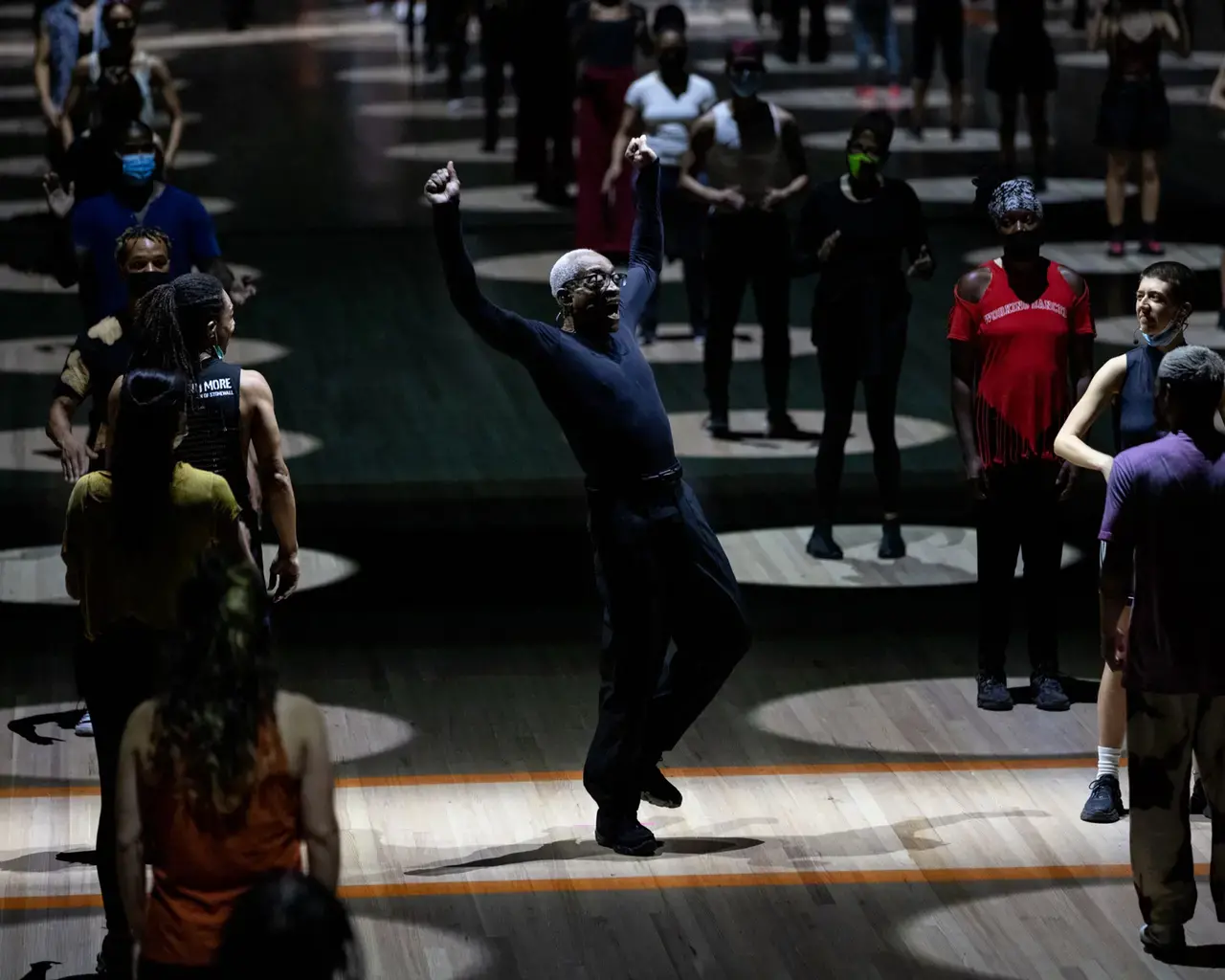 Bill T. Jones, creator, director, and choreographer of Deep Blue Sea, accompanied by a group of community dancers during a performance in New York. Photo by Maria Baranova.&nbsp;