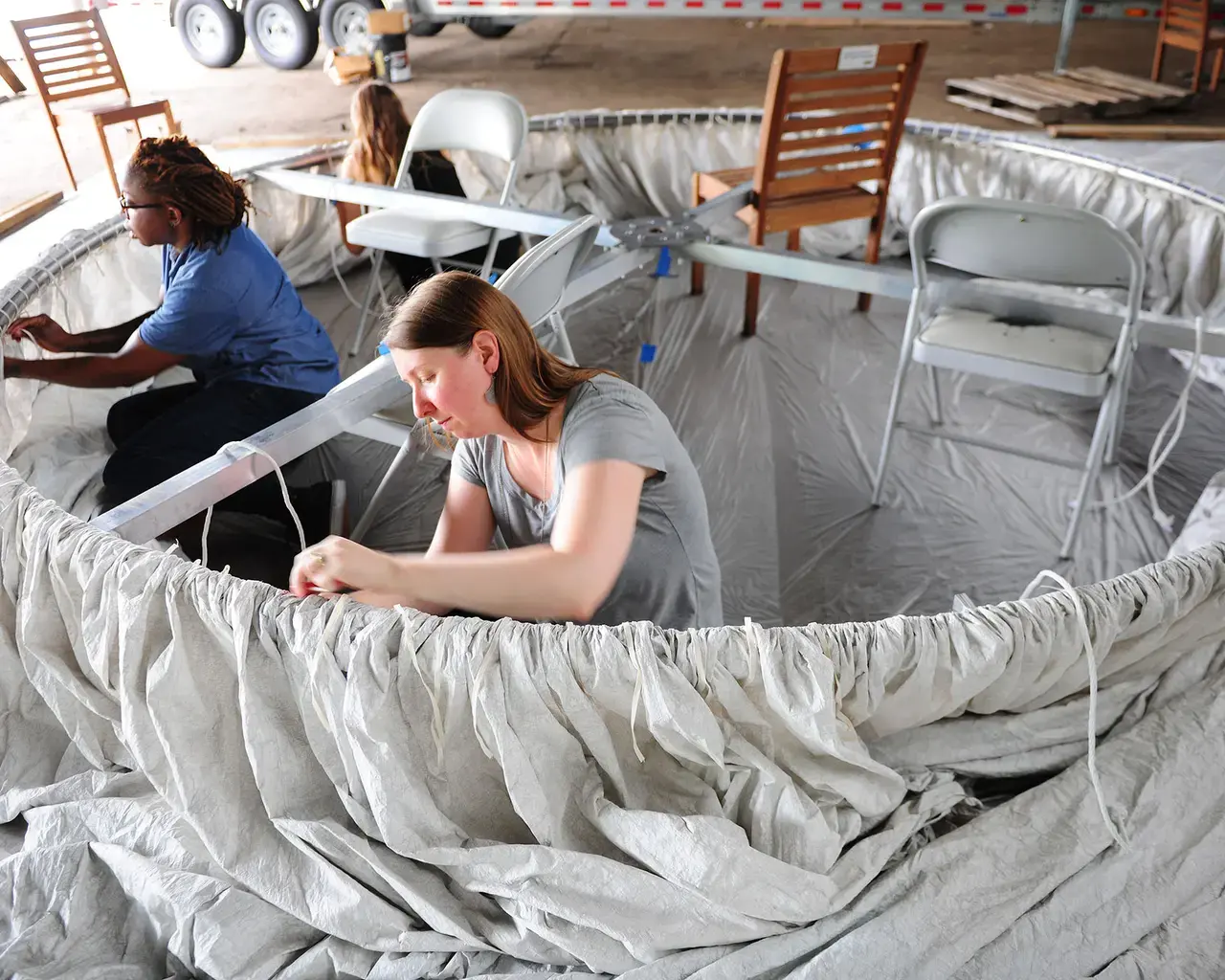 The Fabric Workshop and Museum, studio staff Joy O. Ude and Andrea Landau work on Ann Hamilton’s "habitus"&nbsp;installation at Municipal Pier 9, Philadelphia. Photo by Lonnie Graham.