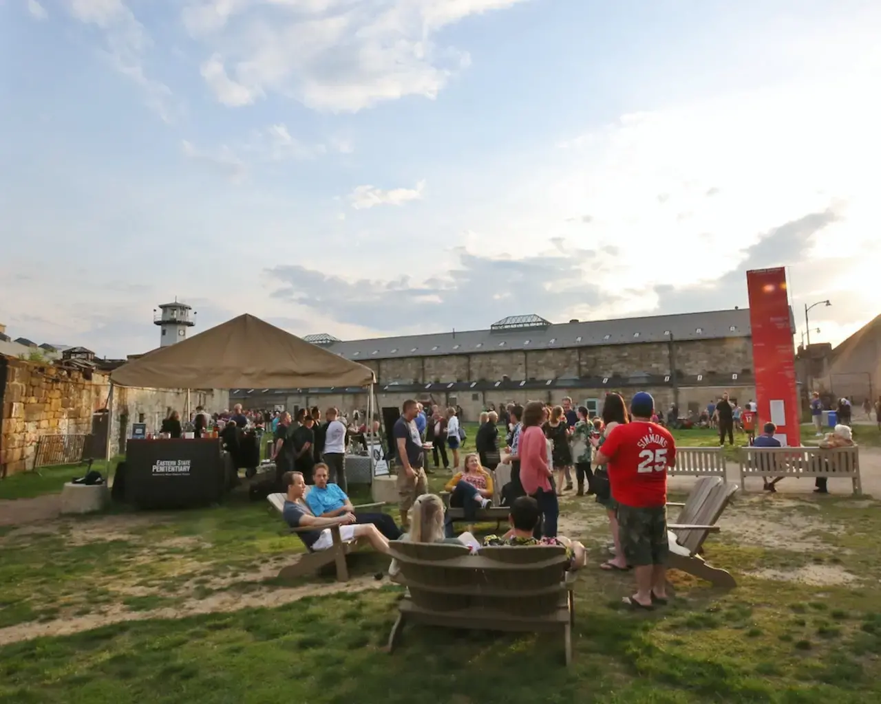 Visitors gather on Eastern State Penitentiary's baseball field for a season reception celebrating its newest site-specific artist installations, 2019. Photo courtesy of Eastern State Penitentiary.
