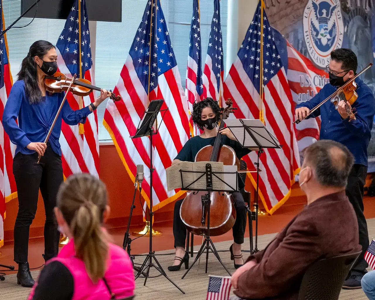 Philadelphia Orchestra musicians Julia Li (violin), Che-Hung Chen (viola), and Yumi Kendall (assistant principal cello) perform during a naturalization ceremony in West Philadelphia, part of the Orchestra's free concert series Our City, Your Orchestra, 2021. Photo by Jeff Fusco.