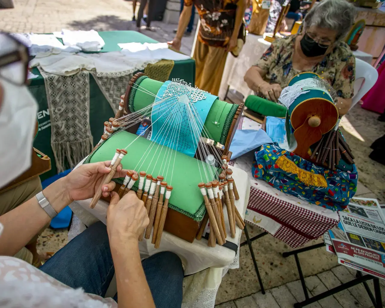 Carmen Arteaga demonstrates the intricate bobbin lace-making technique called mundillo, or “little world.” Guatemalan and Puerto Rican designers are leading textile workshops for Taller Puertorriqueño’s Tramando. Photo by Xavier Garcia, courtesy of Taller Puertorriqueño.