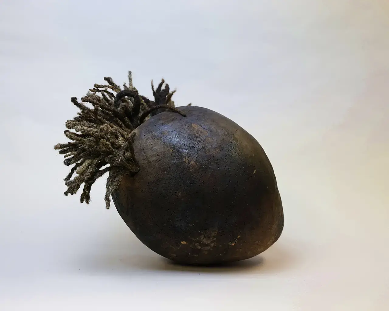 Pew Fellow Adebunmi Gbadebo, Memory of William Ravenel Sr 1860 - 1953 RIP, 2021; True Blue Cemetary soil, Human hair from Linda Street &amp; Juel Ferdinand, Pit fire; 12" x 7.5" x 14.75."&nbsp;