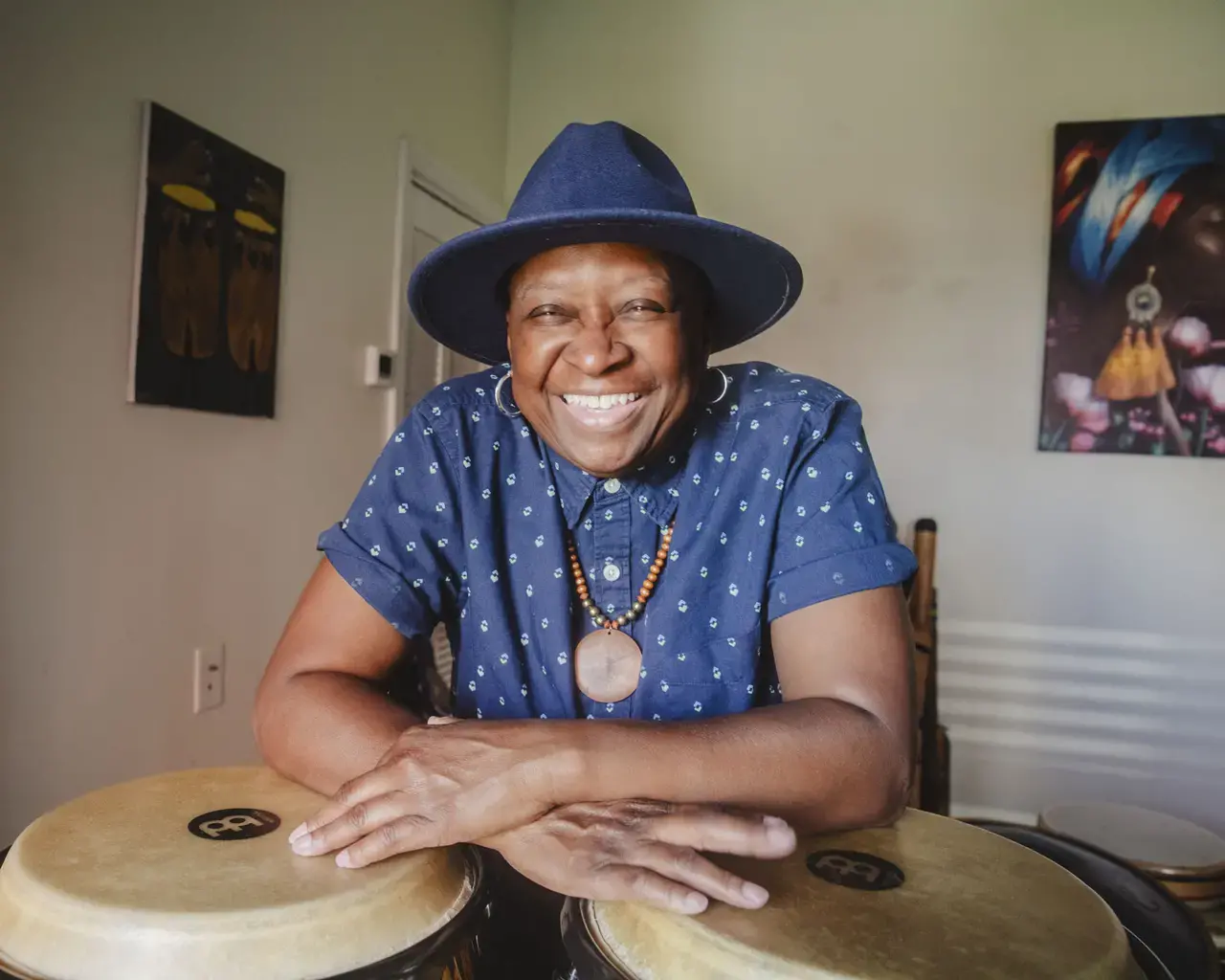 Pew Fellow Karen Smith seated behind drums.