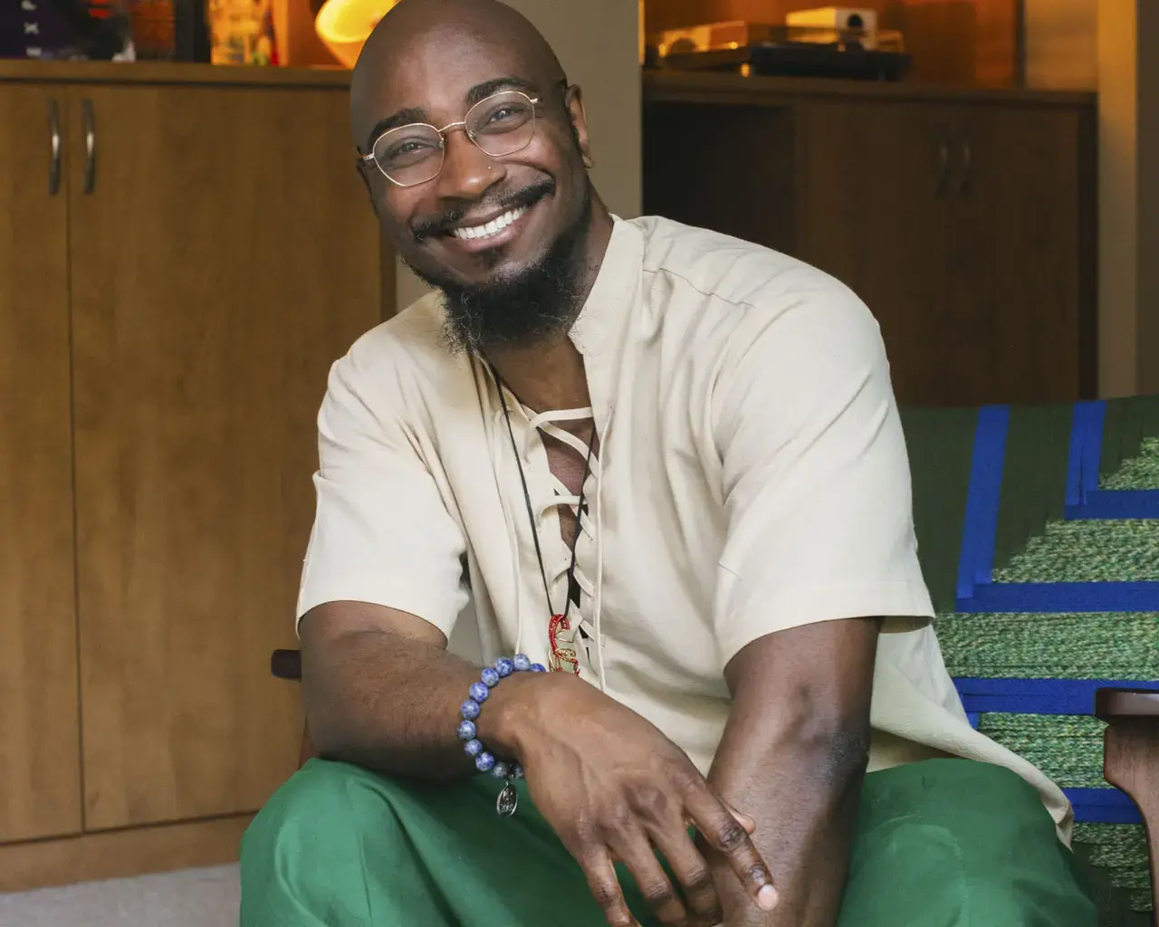 Smiling portrait of Pew Fellow Phillip B. Williams seated.