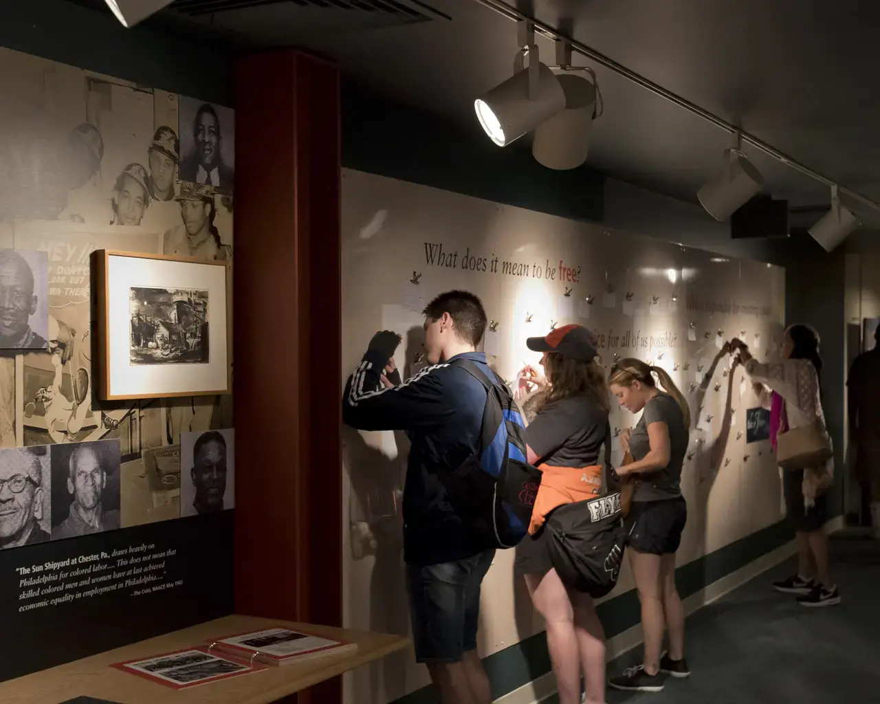 Visitors engage with the exhibit "Tides of Freedom: African Presence on the Delaware River" at the Independence Seaport Museum.