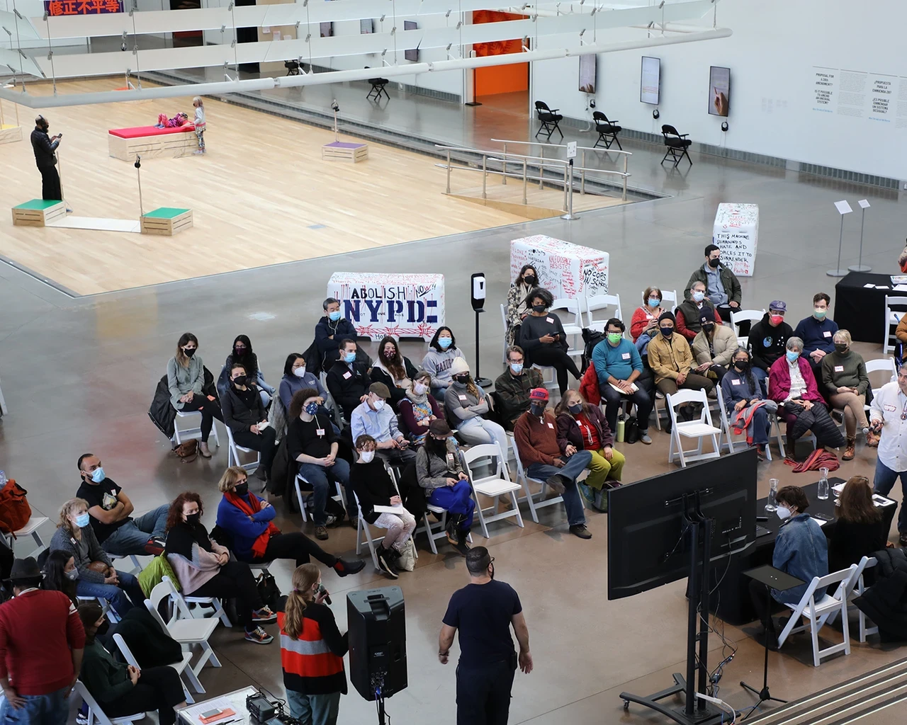 Alex Strada in collaboration with Tali Keren, Proposal for a 28th Amendment? Is it Possible to Amend an Unequal System?, 2021-2025 (Queens iteration 2021-2022), participatory installation with sonic soapbox sculptures, recording booth, evolving oral archive, six 4K videos, and five 60x120” canvas banners, curated by Hitomi Iwasaki and Lindsey Berfond, Queens Museum, Flushing, NY. Photo courtesy of Alex Strada.&nbsp;