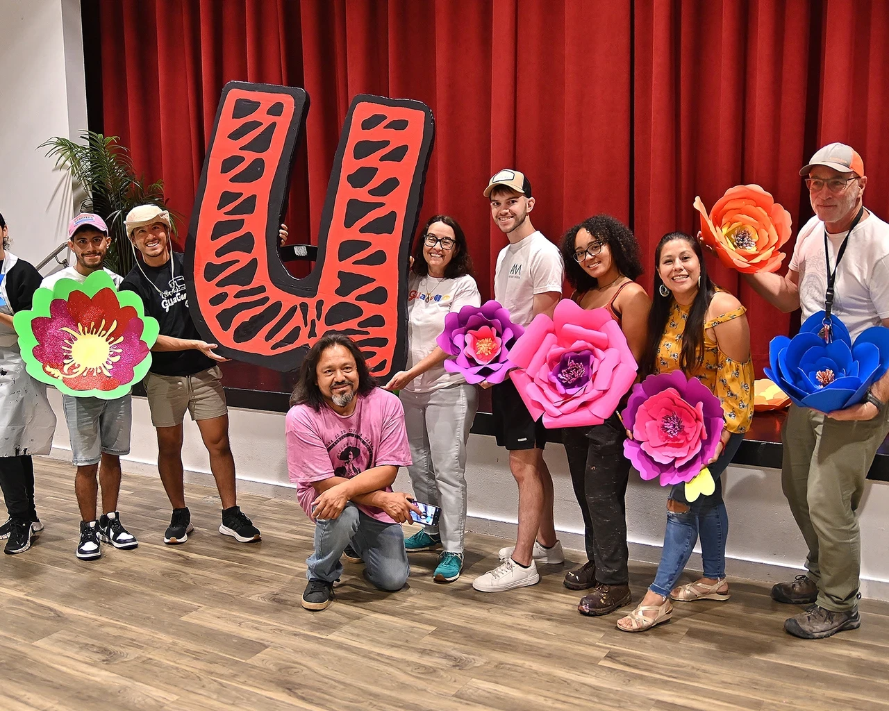 Alba Martínez (center) with community members working together on the La Guagua 47 float during the Puerto Rican Day Parade. Photo taken by Jesús Rincon.&nbsp;