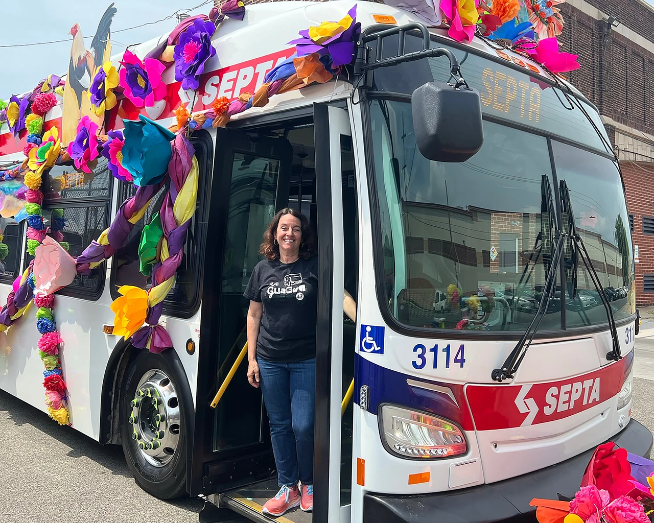 Alba Martínez, creator of La Guagua 47: An American Musical, standing on the SEPTA 47 bus. Photo courtesy of Alba Martínez.&nbsp;