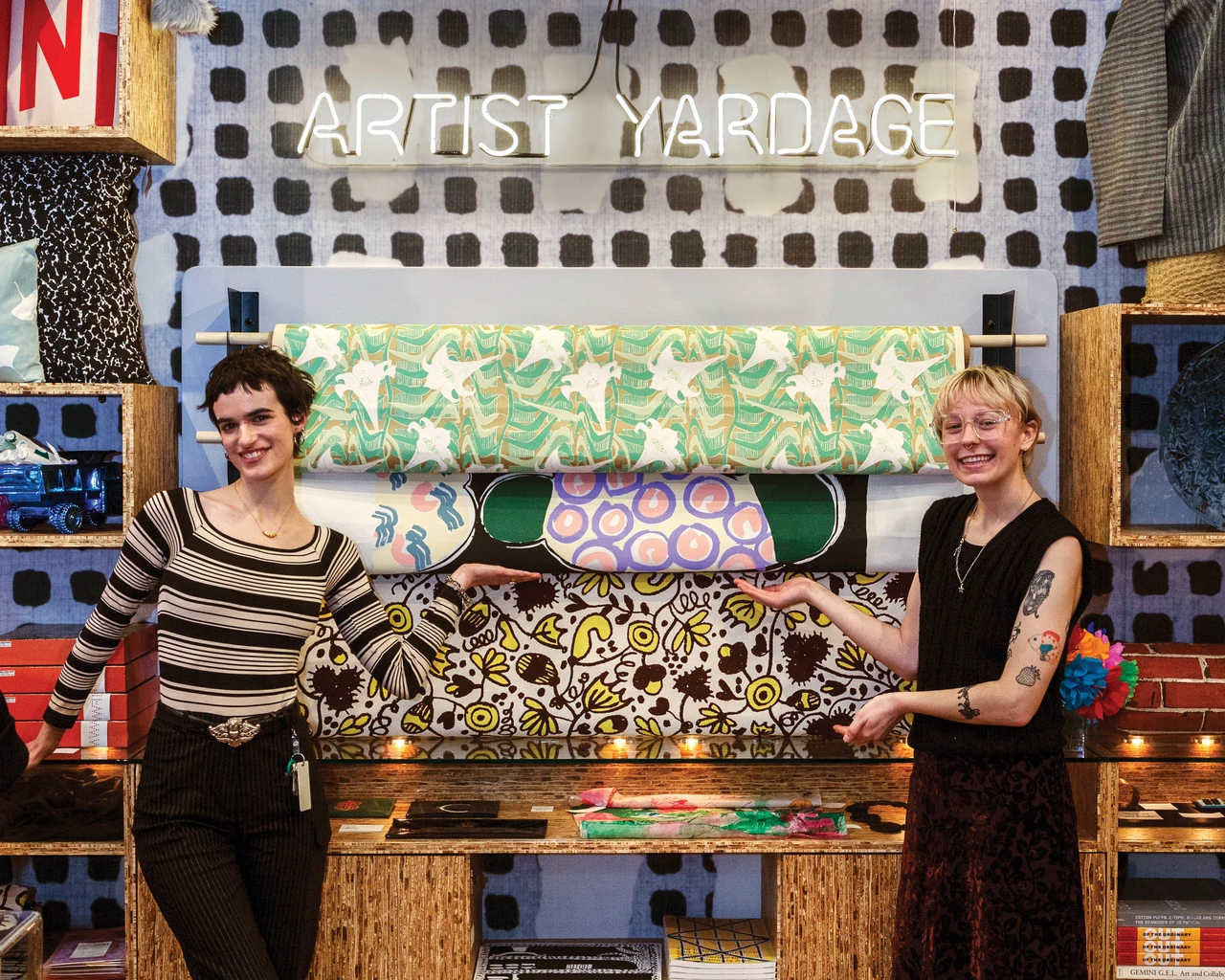 Fabric Workshop and Museum Shop Assistants Olivia Chiaravalli (at left) and Morgan Medl show off the FWM Store’s display of hand-printed yardage. Photo by Carlos Avendaño.