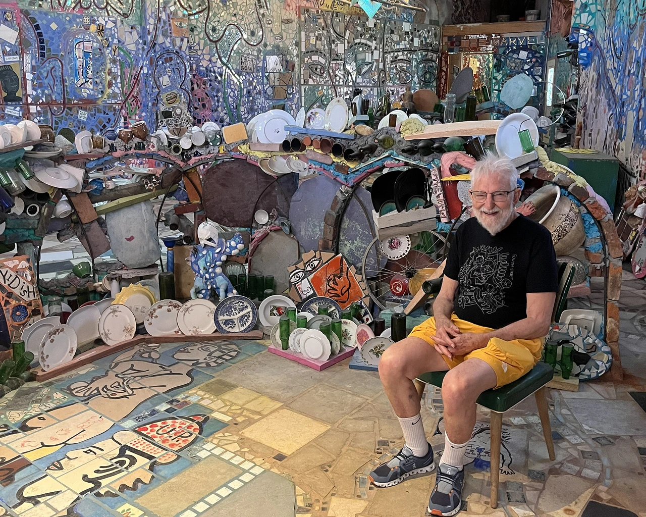 Isaiah Zagar, 1995 Pew Fellow, poses in his Watkins Street Studio in 2024. Photo courtesy of Philadelphia's Magic Gardens.