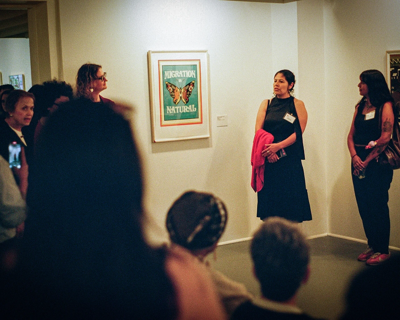 Melissa Govea with her print Migration is Natural at the opening for The Print Center's exhibition America Today. Photo by The Pew Center for Arts &amp; Heritage.