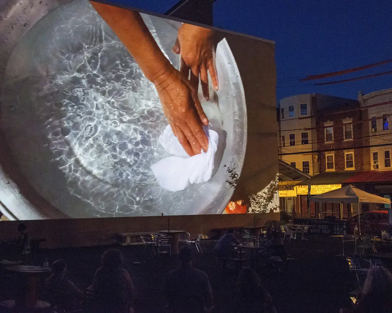 Cleanse, 2020, projection on a Ninth Street Market wall, Philadelphia. Photo by Lori Waselchuk.