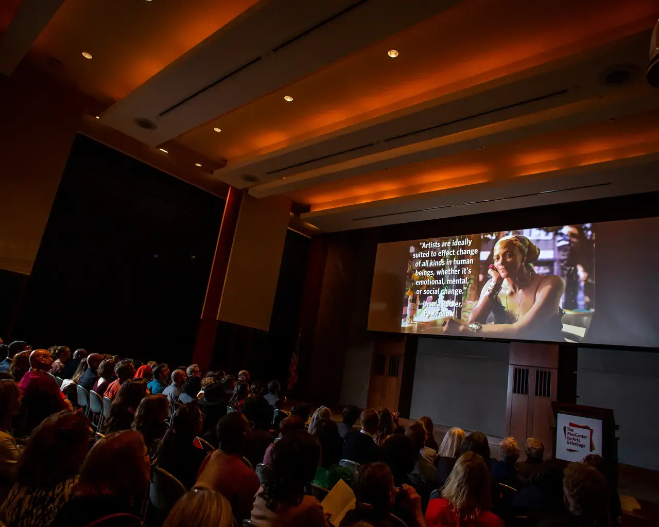 The Pew Center for Arts &amp; Heritage 2019 grantee celebration attendees watch a video highlighting the Center's grant making. Photo by Ashley Smith of Wide Eyed Studios.