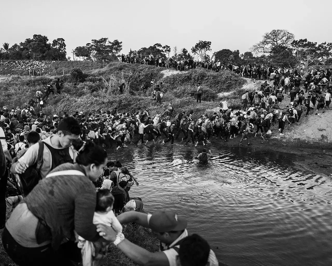 Migrant caravan crossing the river that borders Guatemala and Mexico, 2020. Photo by Pew Fellow Ada Trillo.