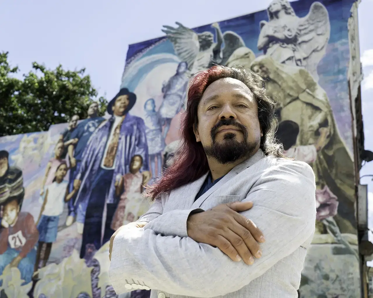 Pew Fellow Cesar Viveros in front of his mural The Journey of the Victims of Crime, Philadelphia, PA. Photo by Irving Viveros.