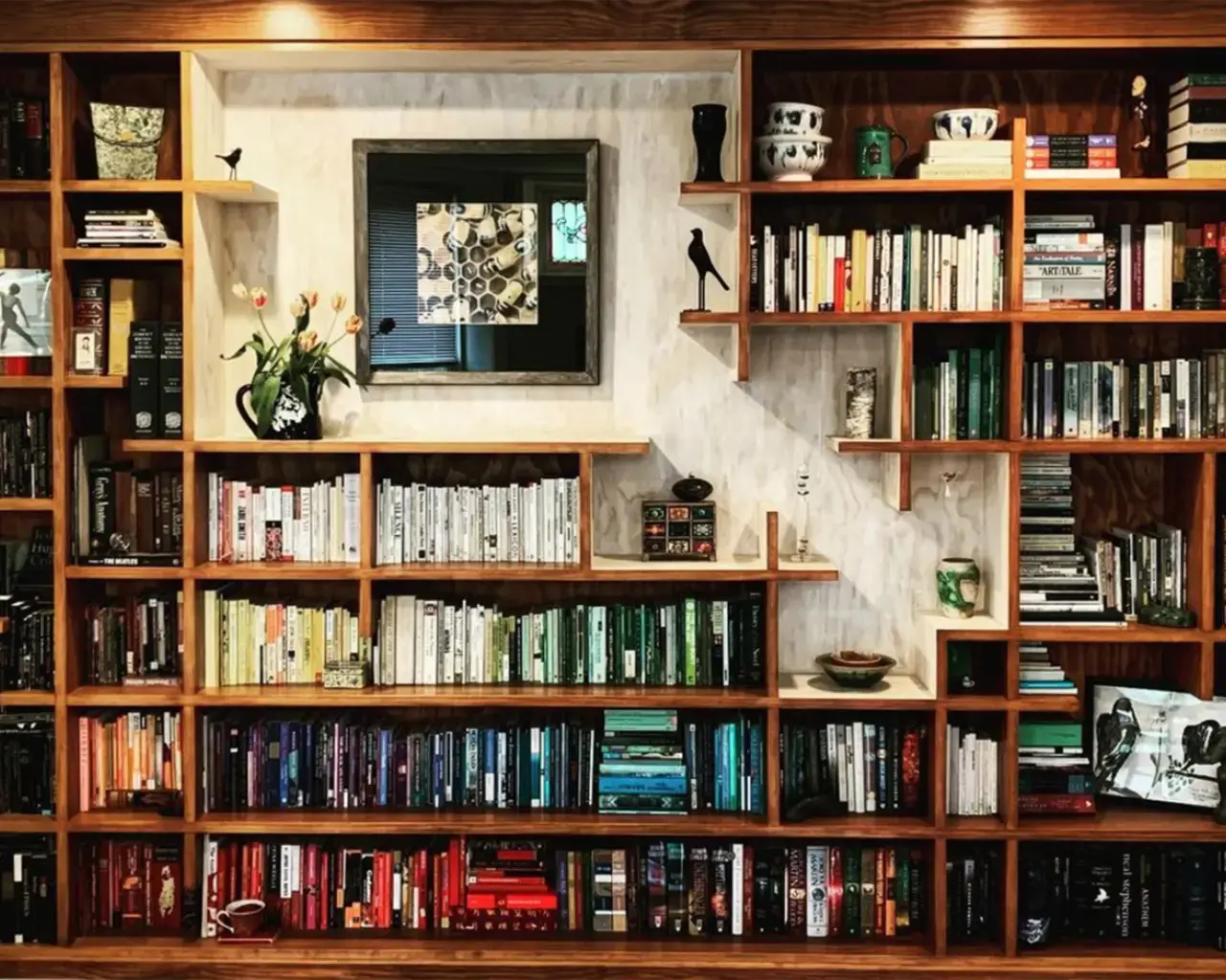 Kirsten Kaschock’s bookshelf, designed and built by the artist’s brother, Misha Kaschock. Photo courtesy of Kirsten Kaschock.