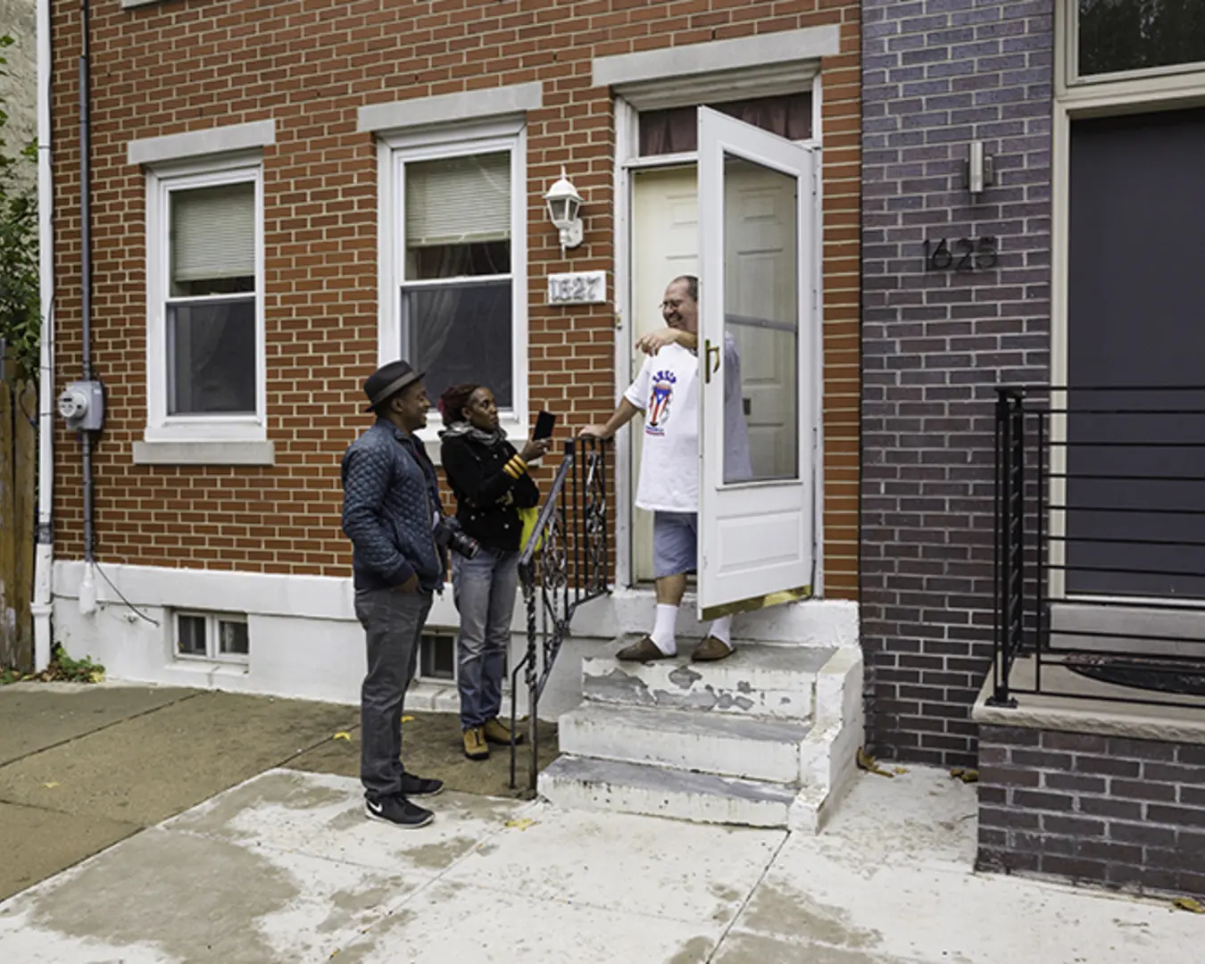 Medea Brooks and Hank Willis Thomas interview South Kensington resident Tony Garcia in November of 2015. Brooks is one of the artist collaborators working with Willis Thomas, who is the lead artist. Photo by Jordan Baumgarten/Philly Block Project.