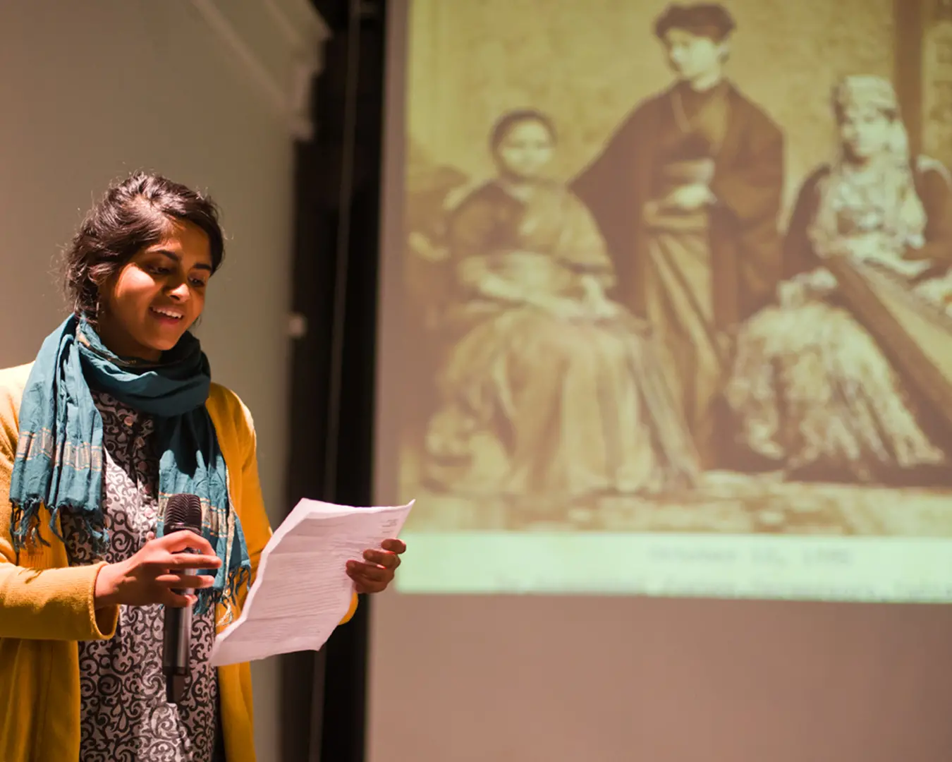 Pavi Jaisankar speaks at a SAADA Community Forum at the Asian Arts Initiative in front of a photograph of Dr. Anandibai Joshee, the first South Asian woman in the world to earn a degree in medicine, 2013. Photo by Vivek G. Bharathan.