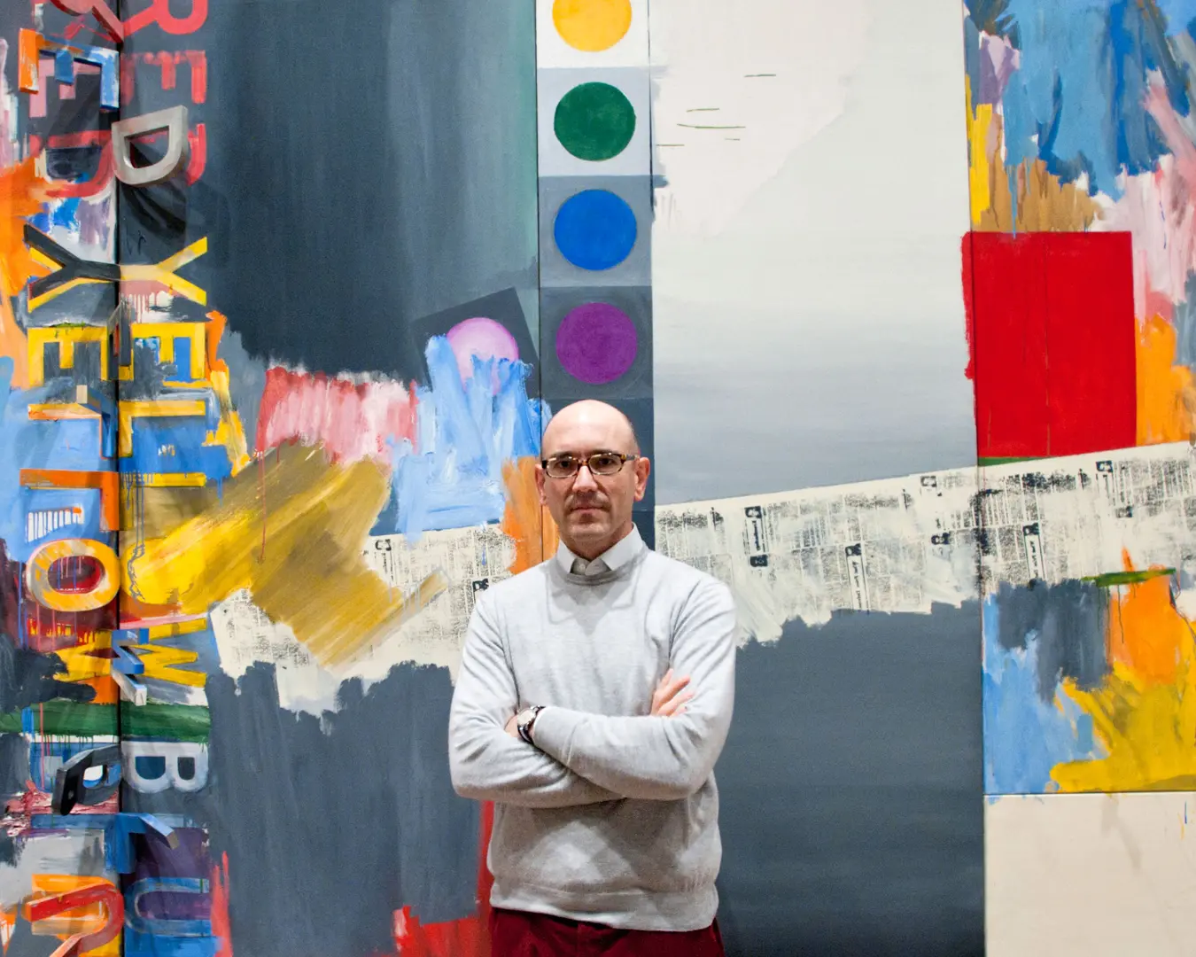 Carlos Basualdo, the Keith L. and Katherine Sachs Curator of Contemporary Art, stands before Jasper Johns' painting According to What&nbsp;(1964) in Dancing around the Bride. Photo by Constance Mensh, courtesy of the Philadelphia Museum of Art.