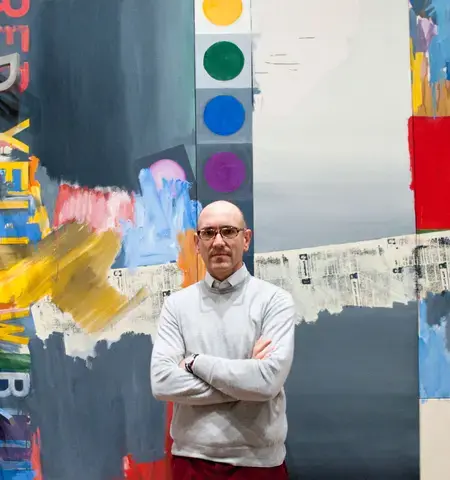 Carlos Basualdo, the Keith L. and Katherine Sachs Curator of Contemporary Art, stands before Jasper Johns&#39; painting According to What&nbsp;(1964) in Dancing around the Bride. Photo by Constance Mensh, courtesy of the Philadelphia Museum of Art.