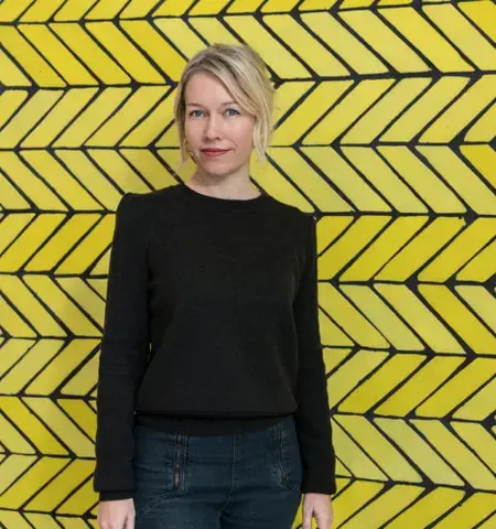 Sarah Crowner in front of&nbsp;Wall (Yellow Teracotta)&nbsp;at the Wright Restaurant at the Guggenheim Museum. Courtesy of David Heald and The Solomon R. Guggenheim Foundation.
