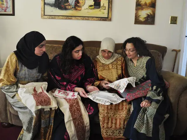 Palestinian needlework (tatreez) artists Wafai Dias, Maisaloon Dias, Alia Sheikh-Yousef, and Nehad Khader look at work. Tatreez patterns from women&rsquo;s home villages, now occupied or destroyed, are assertions of Palestinian history. From the exhibition Tatreez: Needlework of Palestinian women from Philadelphia, curated by Nehad Khader. Photo courtesy of the Philadelphia Folklore Project.