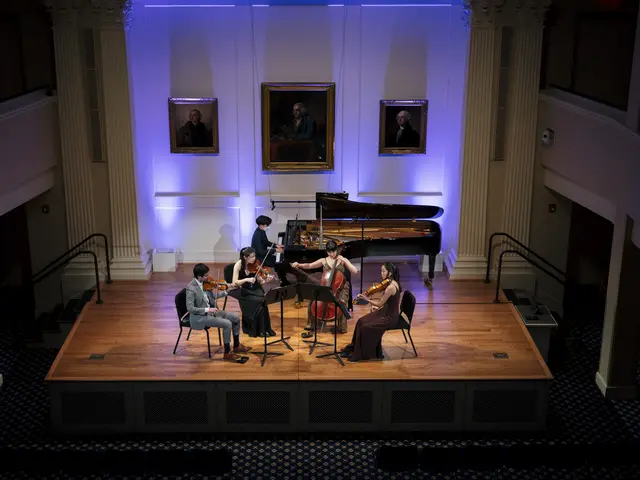 An ensemble of five classical musicans perform on an intimate stage.