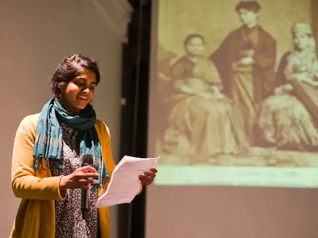 South Asian American Digital Archive, Pavi Jaisankar speaks at a SAADA Community Forum at the Asian Arts Initiative in front of a photograph of Dr. Anandibai Joshee, the first South Asian woman to earn a degree in Western medicine, 2013. Photo by Vivek G. Bharathan.