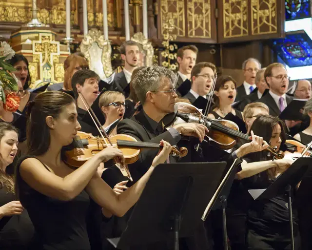 Members of Choral Arts Philadelphia during a pre-concert warm-up, alto and bass section. Photo by Sharon Torello.