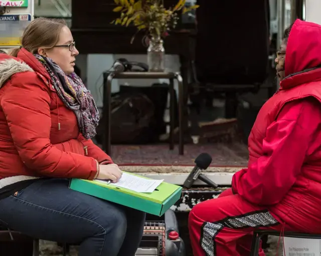 Erin Bernard interviews Gloria King in a vacant lot on North 13th Street in November 2014, for History Truck&#39;s 2015 exhibition They Say They Gonna Build. Photo by Mark Krendel.