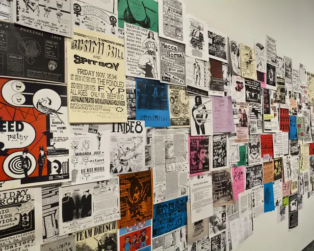 Installation shot of Alien She at the Miller Gallery at Carnegie Mellon University: Posters (c. 1991&ndash;present) from Riot Grrrl related shows, conventions and meetings internationally, solicited from institutional and personal archives through open calls, word-of-mouth, and invitations. Photo courtesy of the Miller Gallery at Carnegie Mellon University.