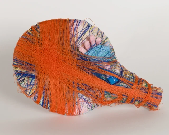 Cindy Gosselin, Untitled, 2022; mixed media sculpture with acrylic thread, wood, tinsel, foam, ping pong racket, plastic doll hand. Image courtesy of the Hurford Center for the Arts and Humanities.